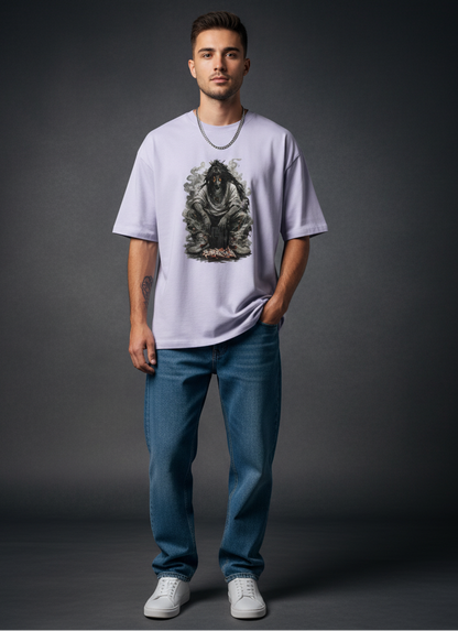 Man wearing a light purple t-shirt with a graphic design and blue jeans on a dark background