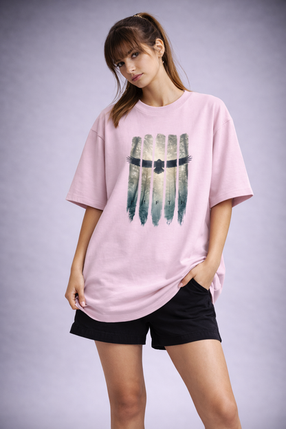 Woman wearing a pink t-shirt with a graphic design on a plain background