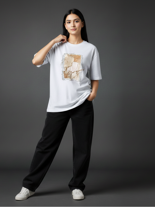 Person wearing a white t-shirt with a graphic design on a gray background