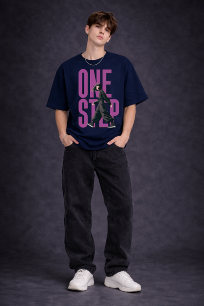 Person wearing a navy blue t-shirt with pink text on a dark background