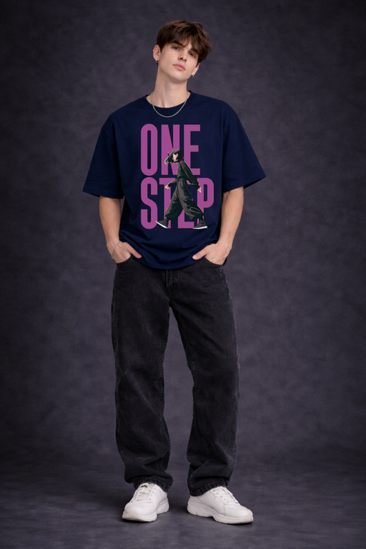 Person wearing a navy blue t-shirt with pink text on a dark background