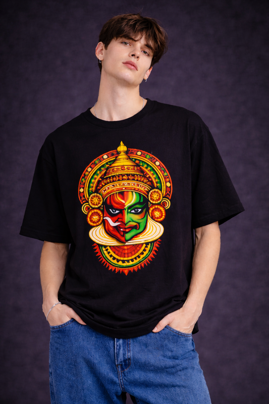 Person wearing a black t-shirt with a colorful graphic design on a dark background