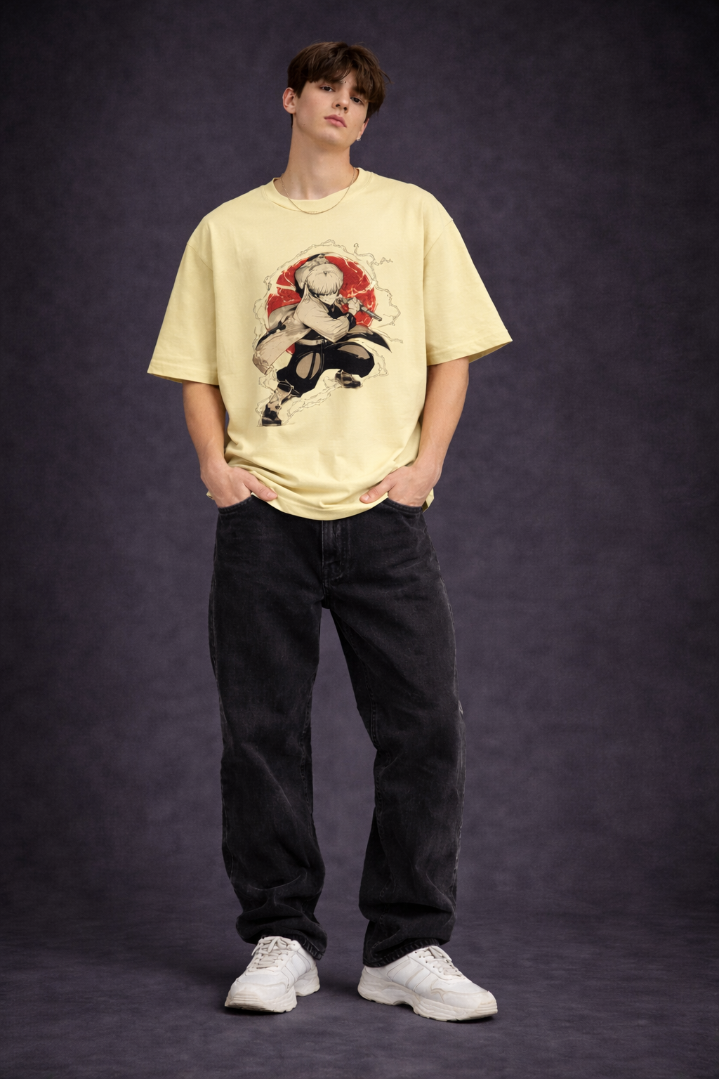 Person wearing a beige t-shirt with a graphic design and black pants on a dark background